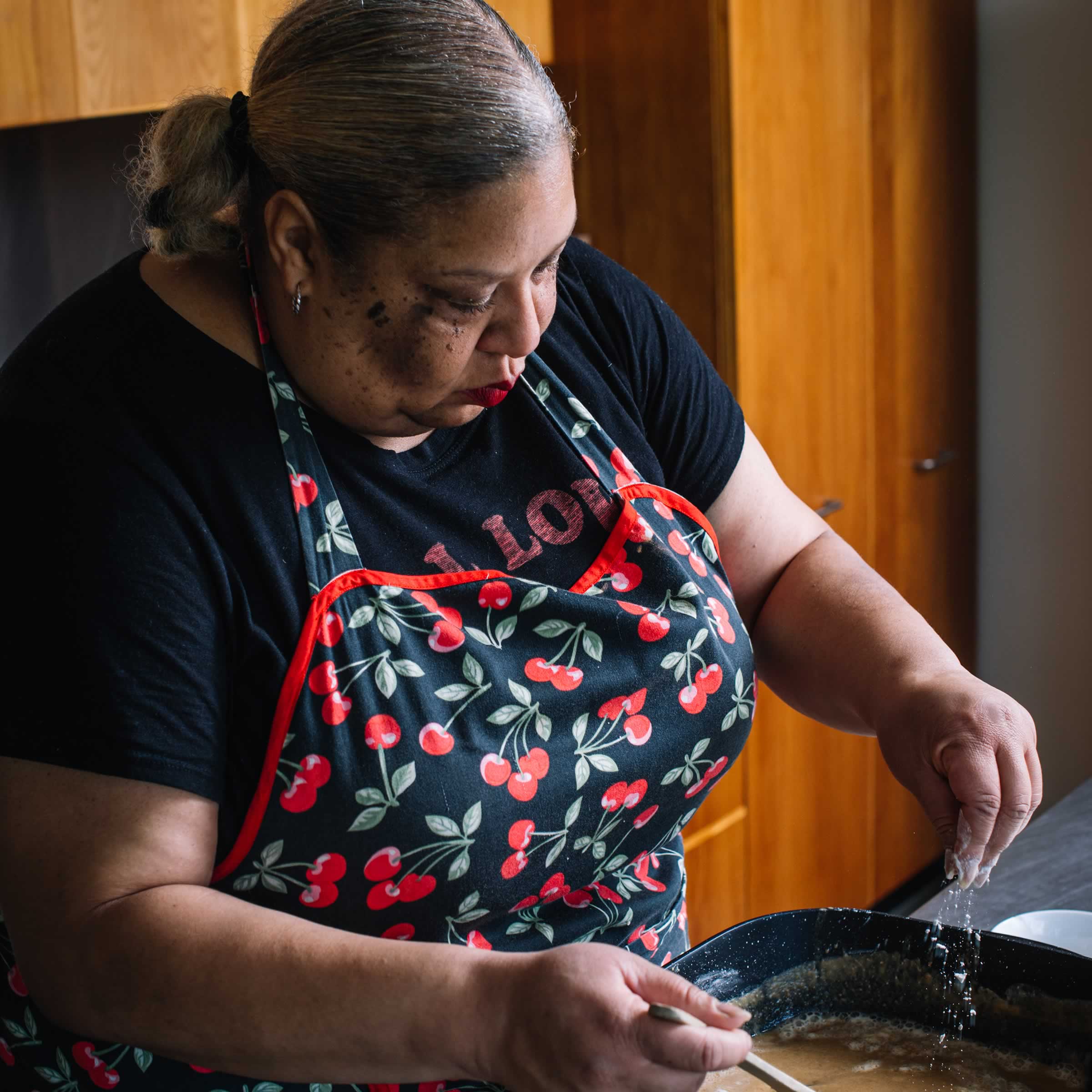 Black and white photo of Honey Child cooking. Photo: Jonathan Wherrett.